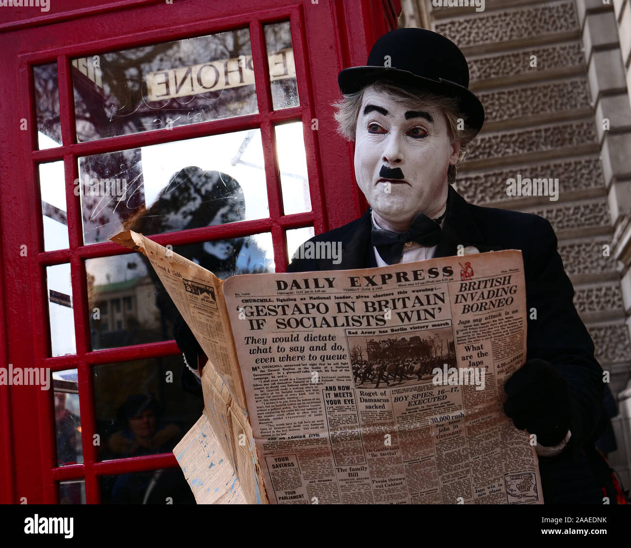 London, UK. 18th November, 2019. Charlie Chaplin seen reading an edition of the Daily Express from Tuesday June 5, 1945 with a major headline Churchill, fighting as Nationalist leader during the election, gives electors this warning: 'Gestapo in Britain if Socialists win.' Credit: Joe Kuis / Alamy News Stock Photo