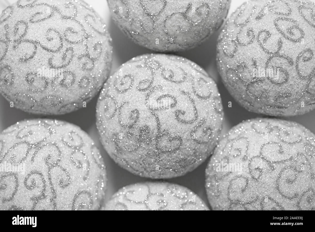 Christmas background. White Christmas balls with silver pattern close-up. Beautiful Christmas Wallpaper. Stock Photo