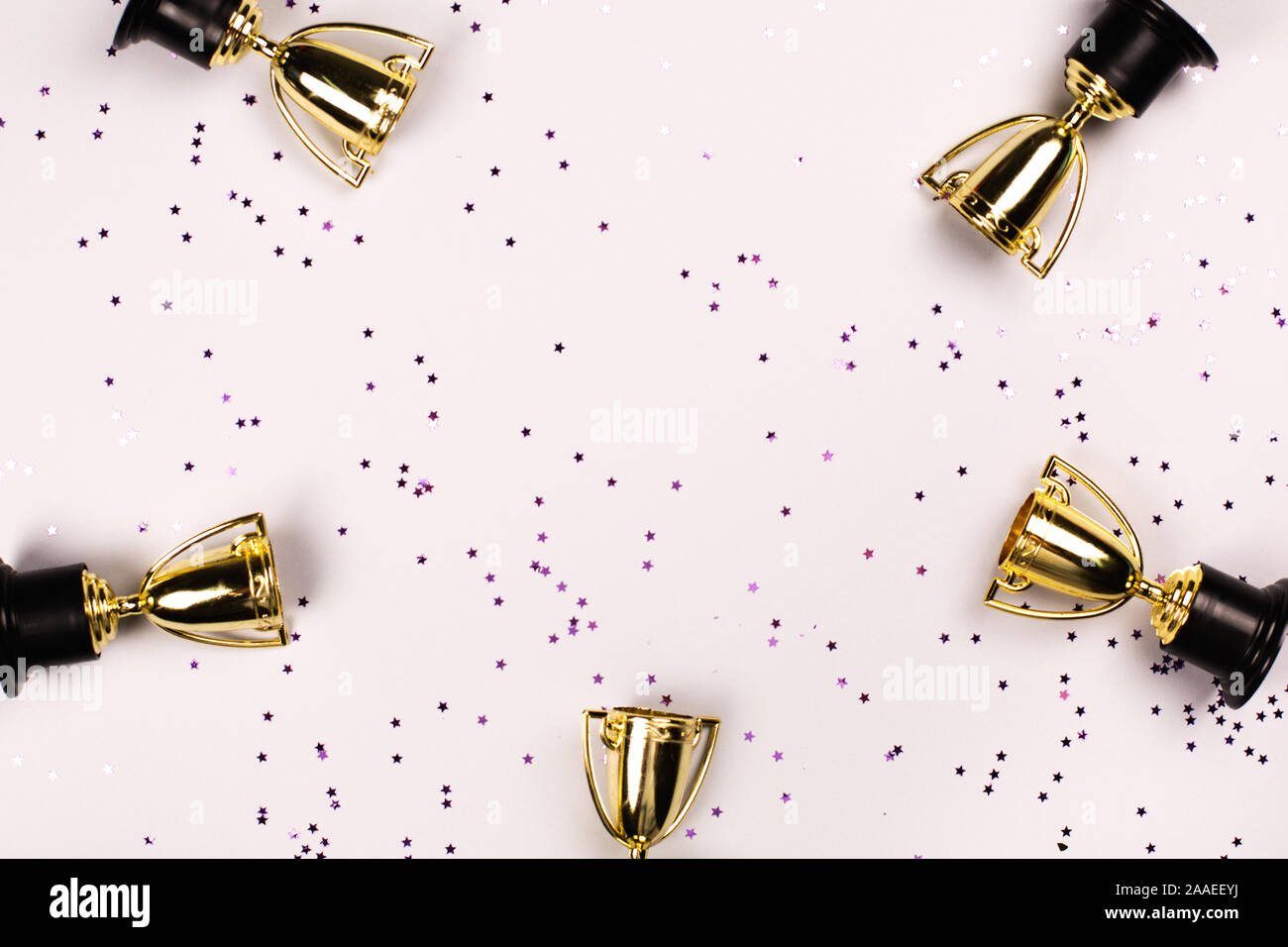 Winner or champion cup on bright background, Flat lay style. Open composition. Stock Photo