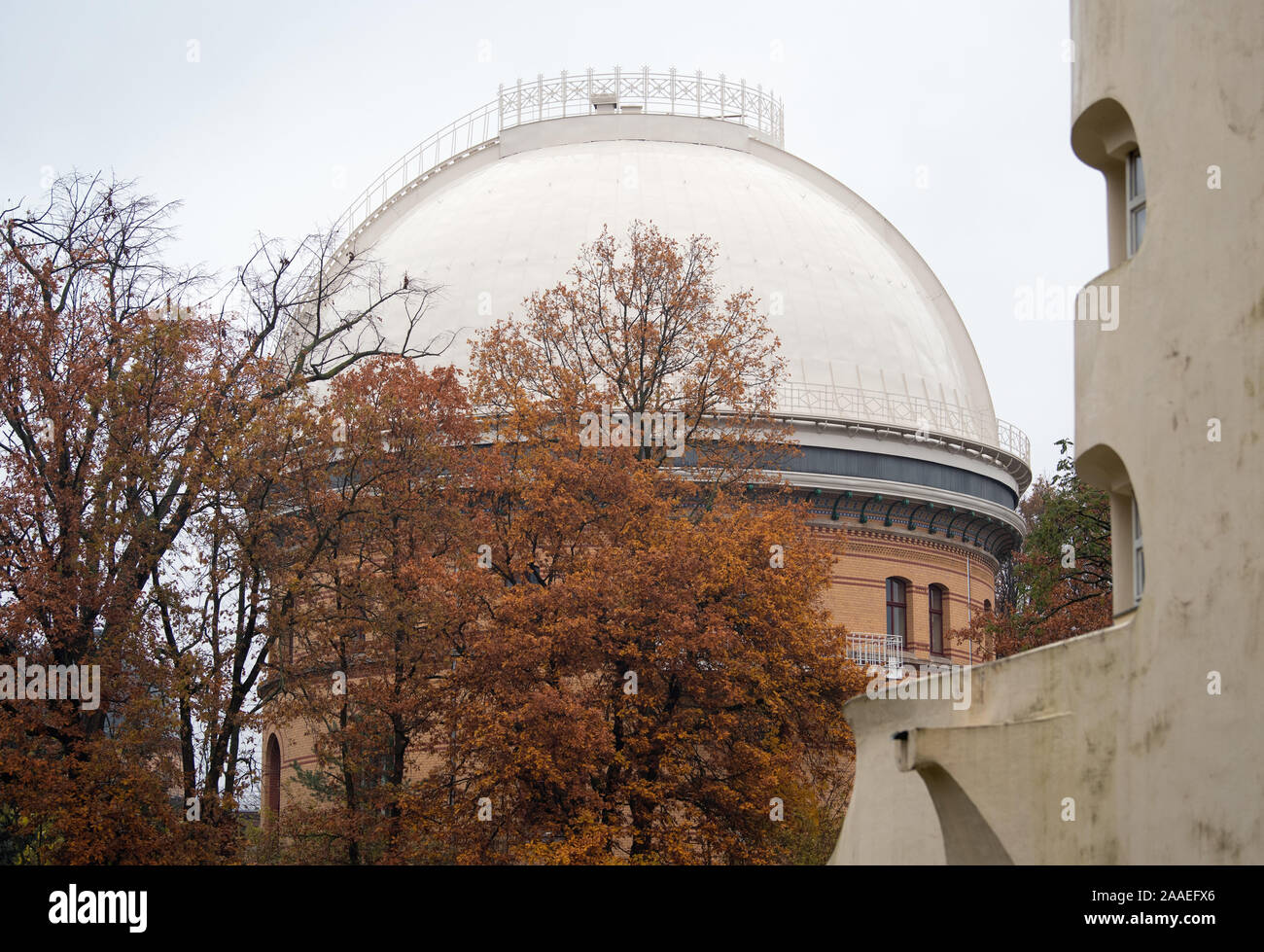 Potsdam, Germany. 18th Nov, 2019. The Einstein Tower (r), designed by Erich Mendelsohn, and the dome of the Great Refractor of the Astrophysical Institute between autumnal leafy trees in the Albert Einstein Science Park. The park was created in the middle of the 19th century with astronomical, meteorological and geoscientific observatories. The architect Paul Spieker was the planner of the park. Credit: Soeren Stache/dpa-Zentralbild/ZB/dpa/Alamy Live News Stock Photo