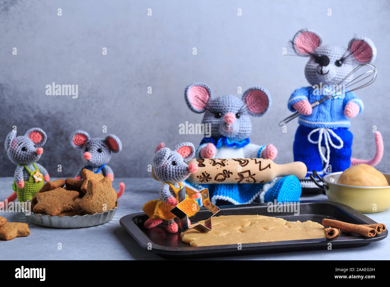 Knitted mouse family is cooking cookies. Year of rat. symbol of 2020. Stock Photo