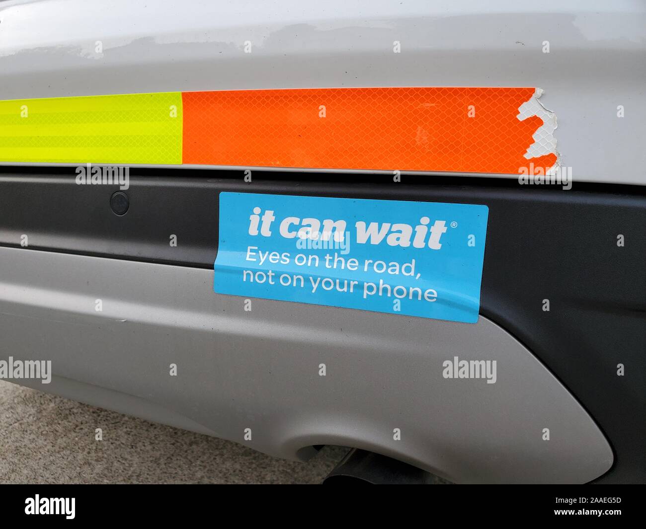 Close-up of bumper sticker on ATT vehicle with text reading It Can Wait, part of a public service advertising campaign to discourage text messaging while driving, San Ramon, California, November 13, 2019. () Stock Photo