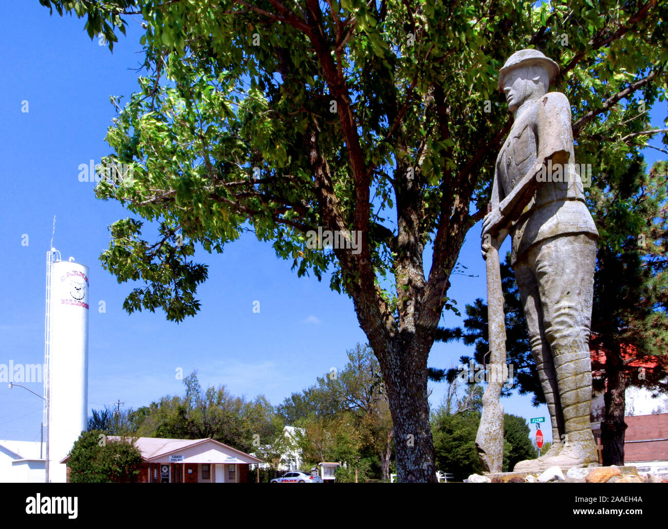 A full length concrete and stone statue of a World War I Dough Boy soldier stands in Woody Wilson Memorial Park in the small town of Carney Oklahoma. Stock Photo