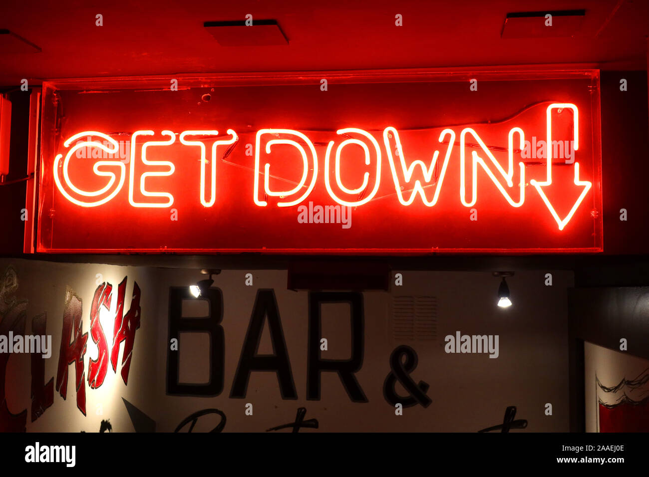 Red Neon Sign, Get Down with an arrow Stock Photo