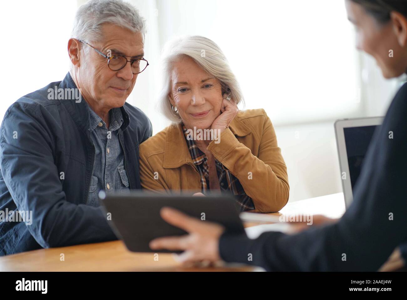 Modern senior couple going through remodelling ideas on tablet Stock Photo