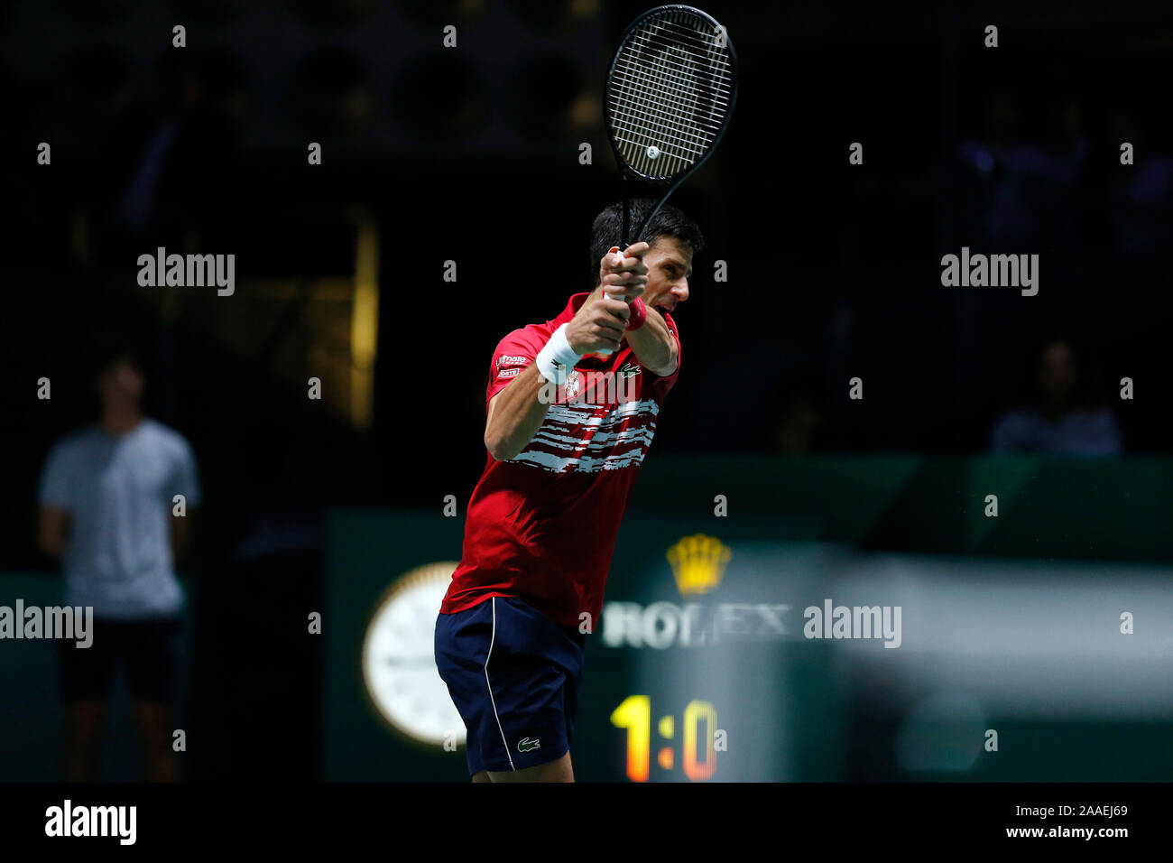 Novak Djokovic of Serbia in action against Benoit Paire of France during Day 4 of the 2019 Davis Cup at La Caja Magica. Stock Photo
