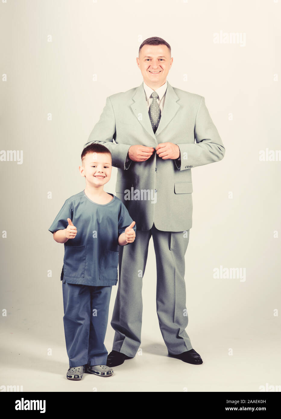 future career. childhood. trust and values. fathers day. family day. father and son in business suit. male fashion. happy child with father. business partner. small boy doctor with dad businessman. Stock Photo