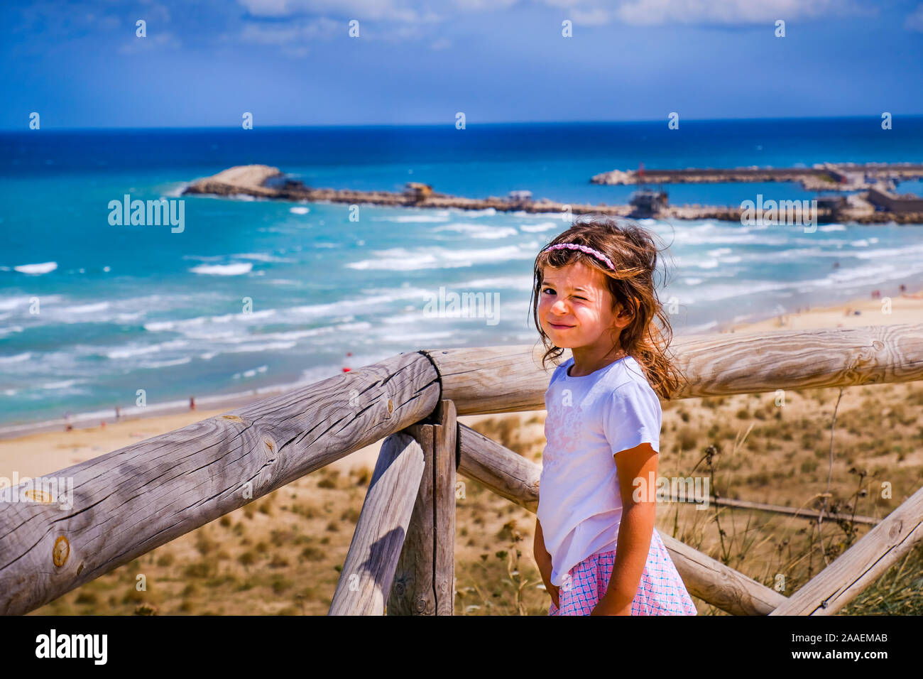 cute sweet nice smart look brat little girl baby wink with colorful summer seascape background Stock Photo