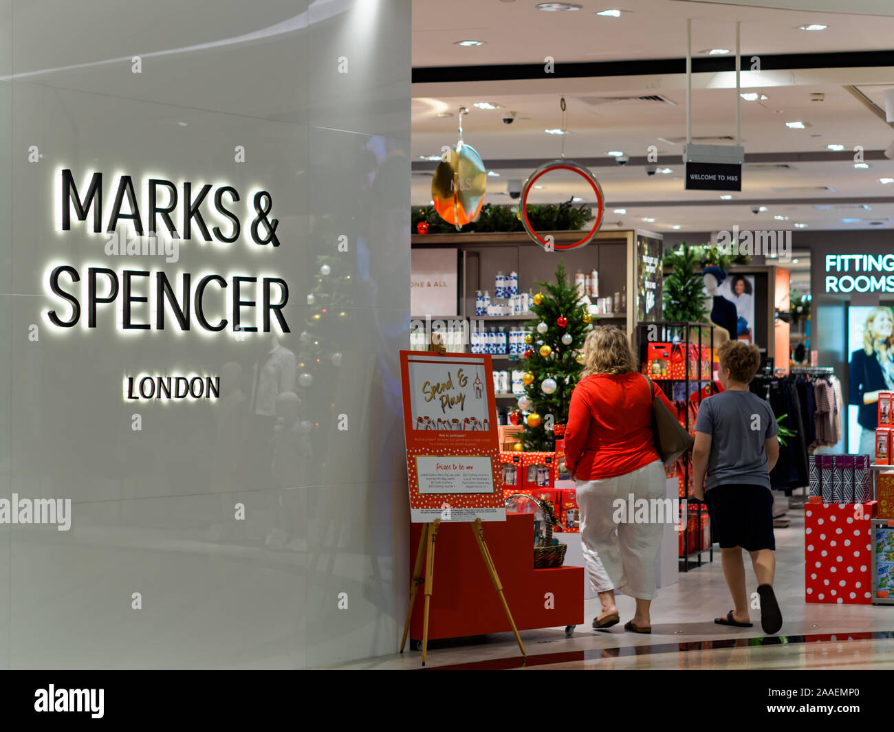SINGAPORE - 17 NOV 2019 – Back view of shoppers enter a Marks & Spencer store at Jewel, Changi Airport, Singapore Stock Photo