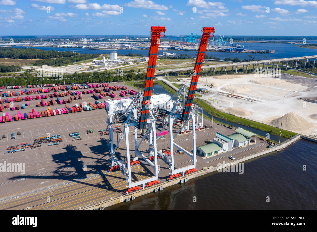 Shipping port terminal cranes ready to discharge container ship. Stock Photo