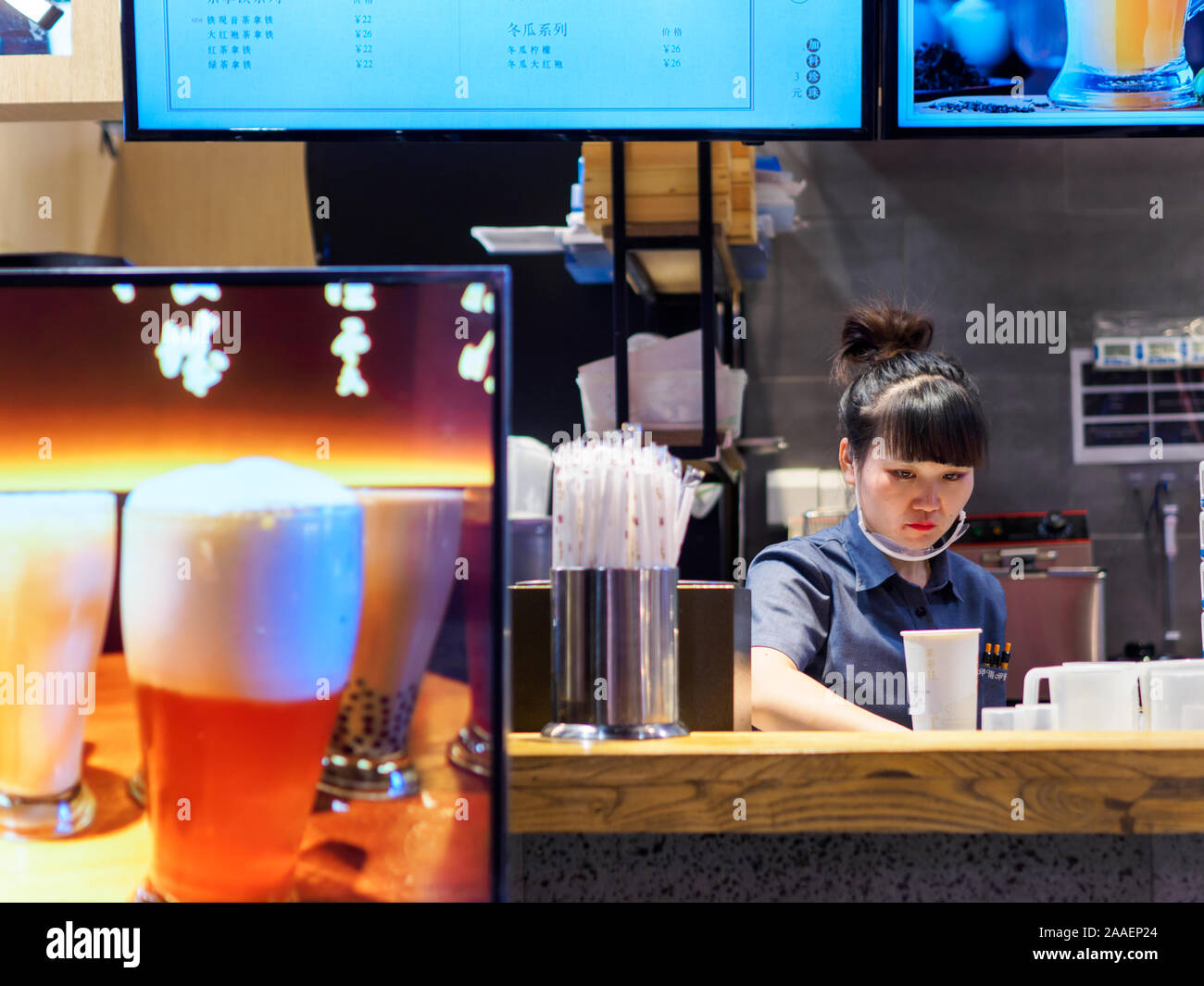 TIANJIN, CHINA - 7 OCT 2019 - A bubble tea stall employee within a shopping mall preparing a drink for customers. Food & beverage / consumer culture t Stock Photo