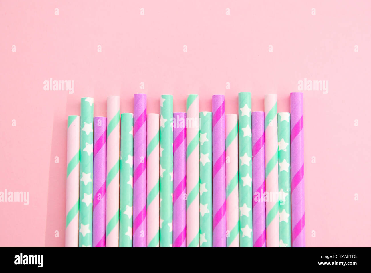 Colorful Paper coctail tubes on the pink background. Eco friendly. Zero Waste. Isolated Stock Photo