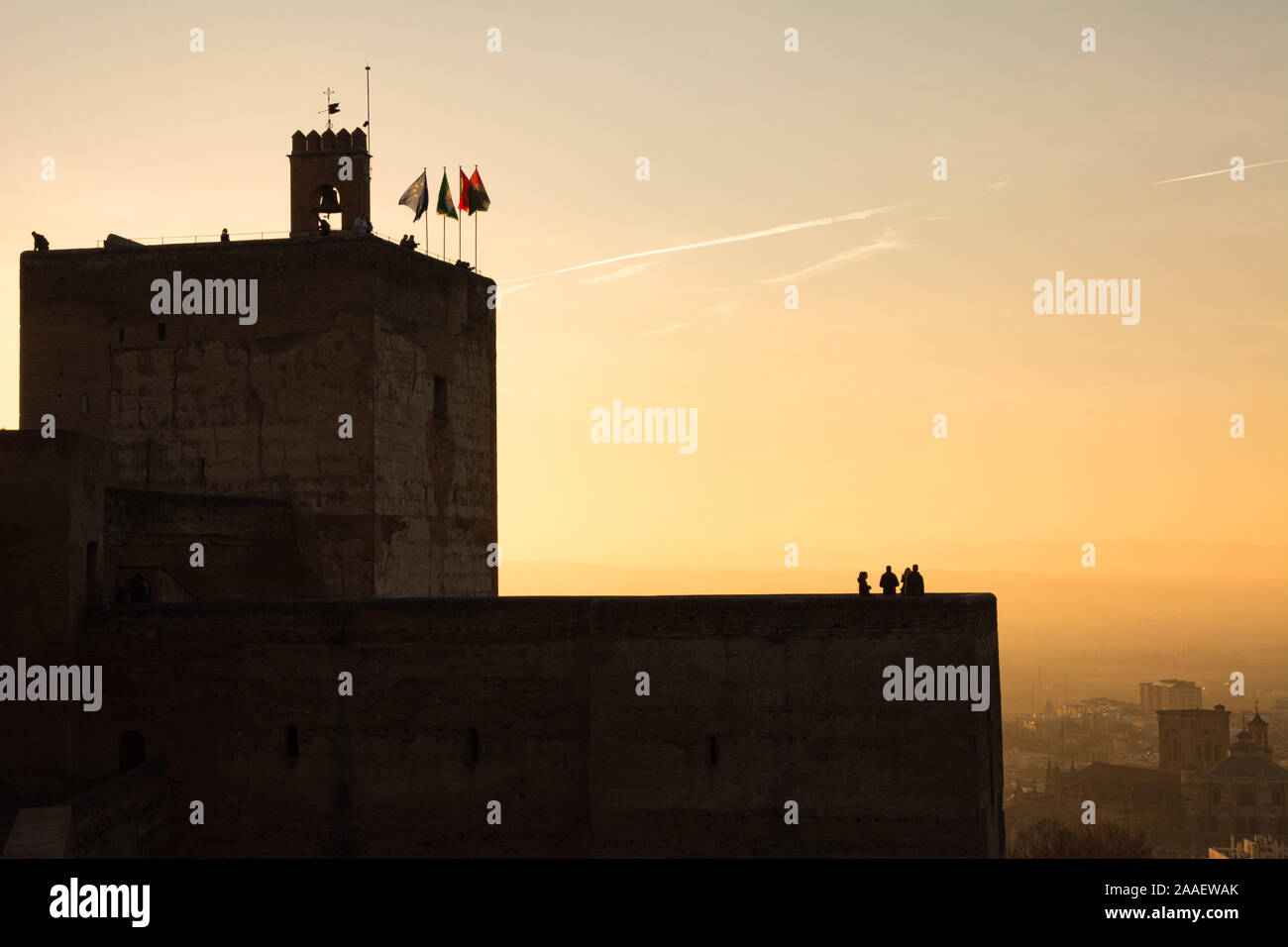 People silhouetted on the Torre De La Vela and Torre de las Armas at sunset, at the Alcazaba fortress of the Alhambra palace complex, Granada, Spain. Stock Photo