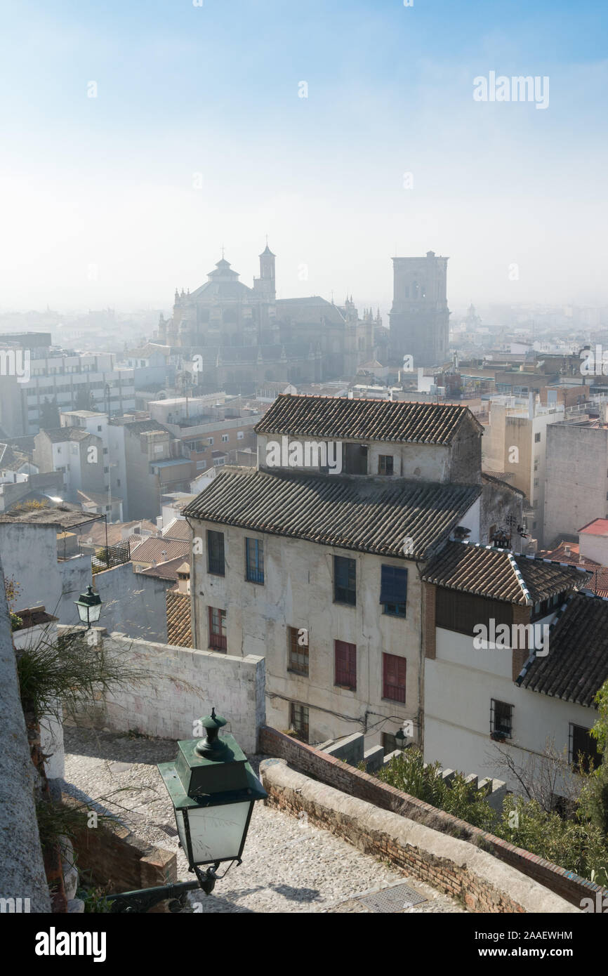 A view of Granada Cathedral over the rooftops in the Albaicín neighbourhood on a fine but misty winter day Stock Photo