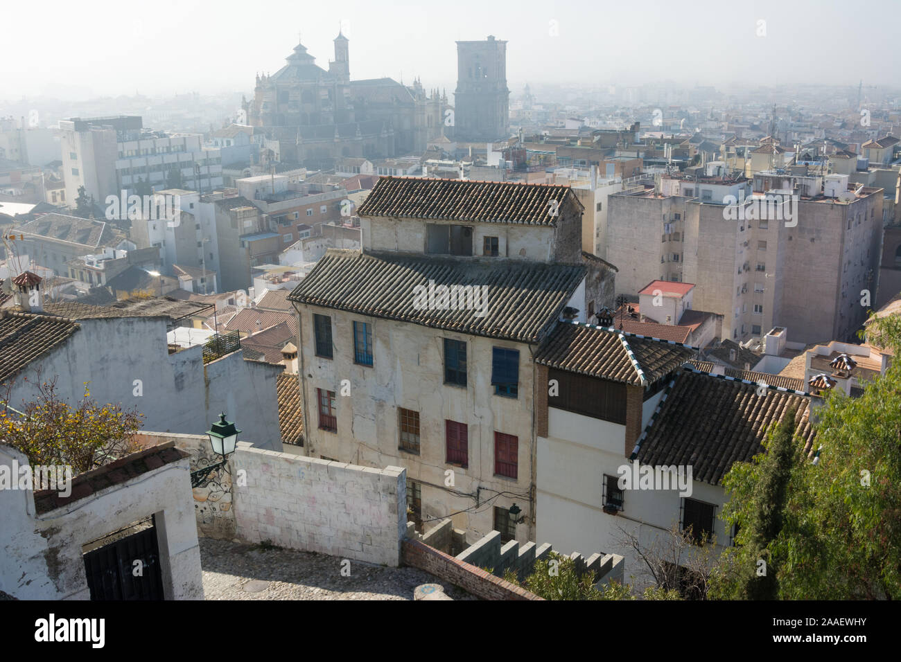A view of Granada Cathedral over the rooftops in the Albaicín neighbourhood on a fine but misty winter day Stock Photo