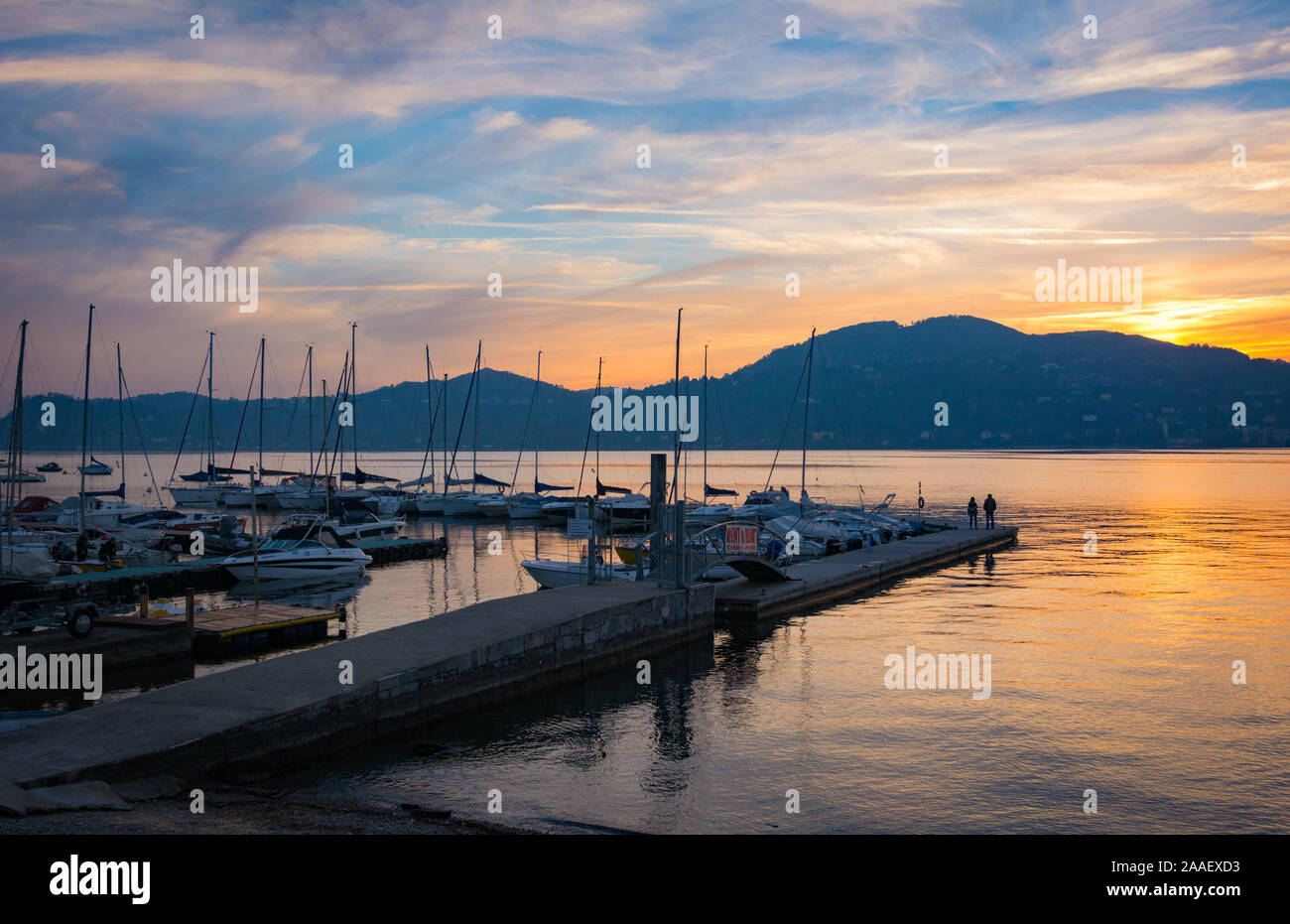 A mooring for boats at sunset on the banks of Lake Maggiore in Italy Stock Photo