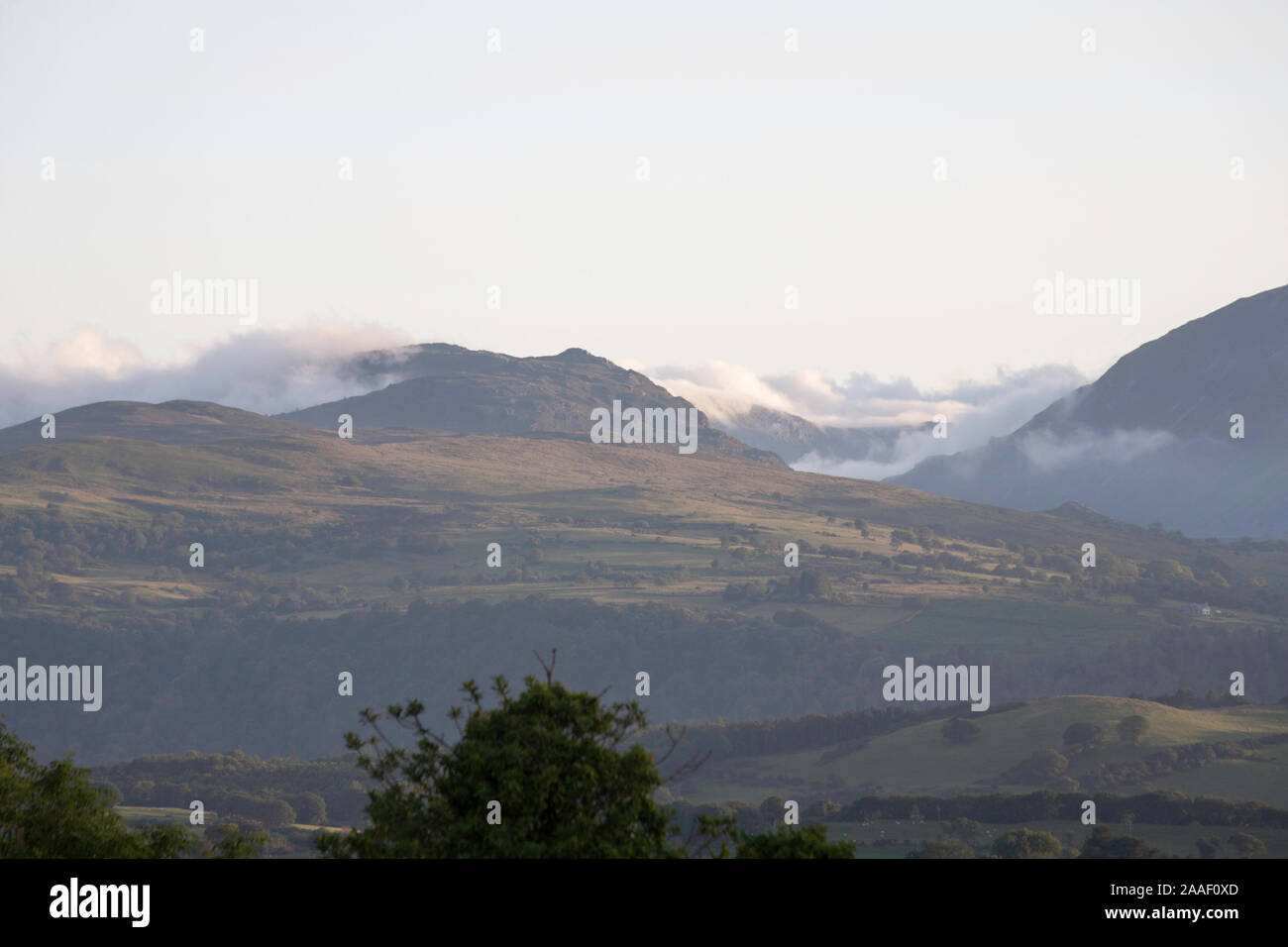 Morning mist surrounding  mountains along the Vale of Conwy Snowdonia on a summer morning near  the village of Eglwysbach Conwy North Wales Stock Photo