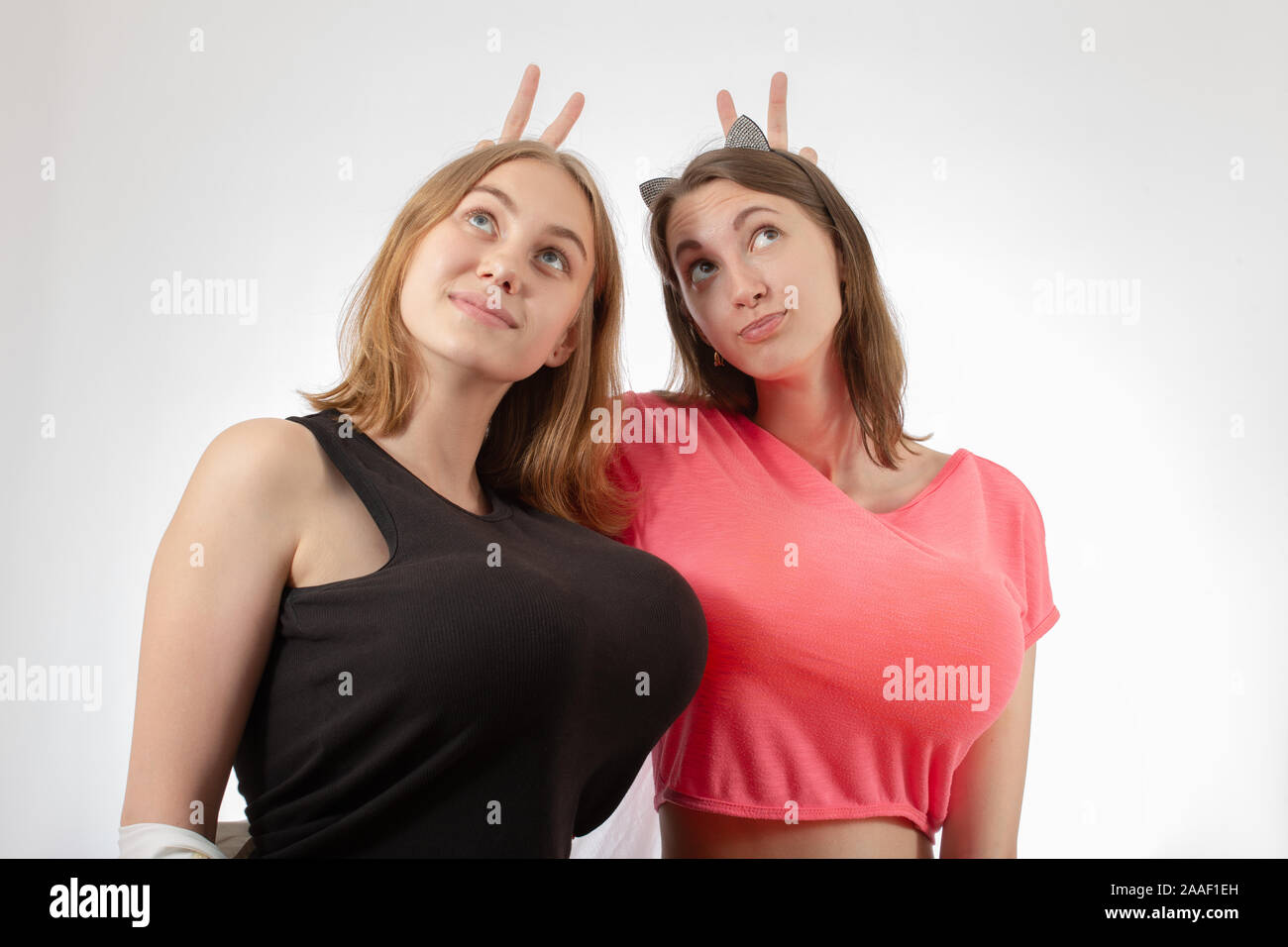 young woman with big fake breasts isolated on white background looking