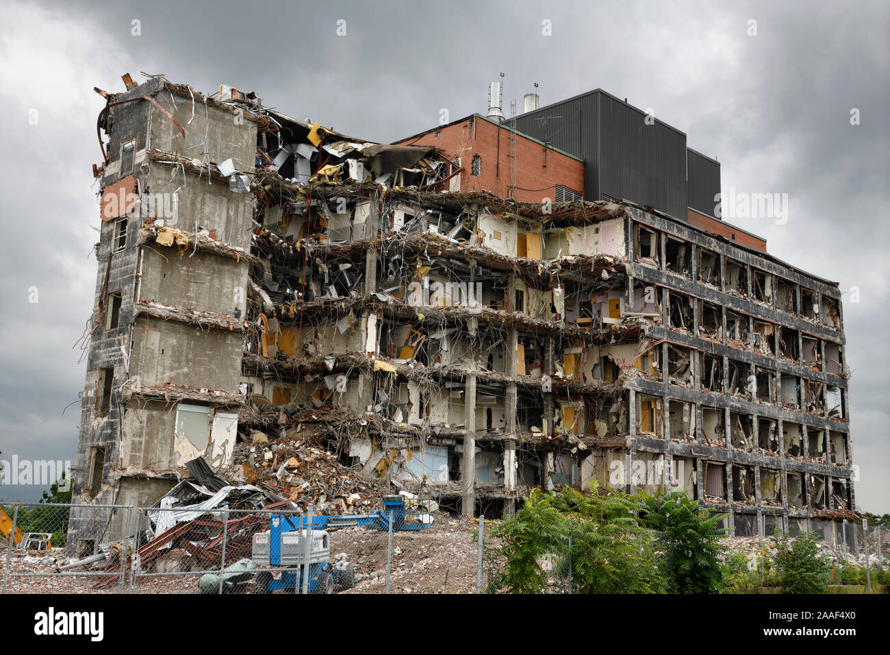 Highrise apartment building in the process of being demolished under gloomy gray sky in St Catherines Canada Stock Photo