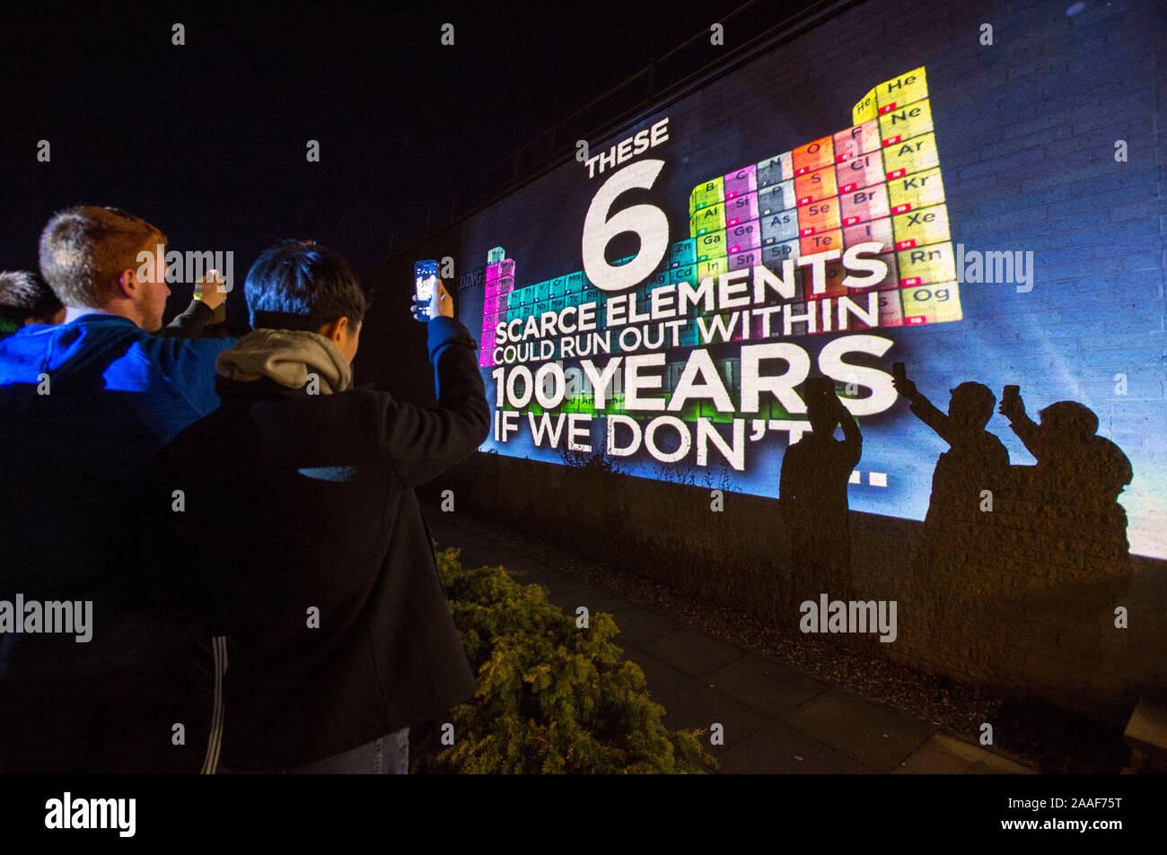 Students hold up mobile phones against a light display at the University of St Andrews showing the Periodic Table coming alive in support of Chemistry Week. Stock Photo