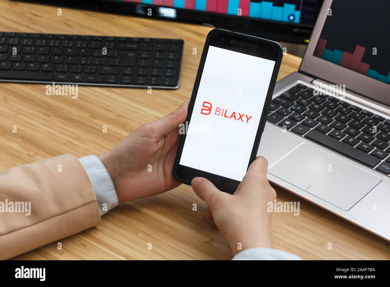 BiLaxy Cryptocurrency Exchange Market. Female Trader Hands Holding the  Smartphone Using Application. Crypto Background Concept, San Francisco  Stock Photo - Alamy