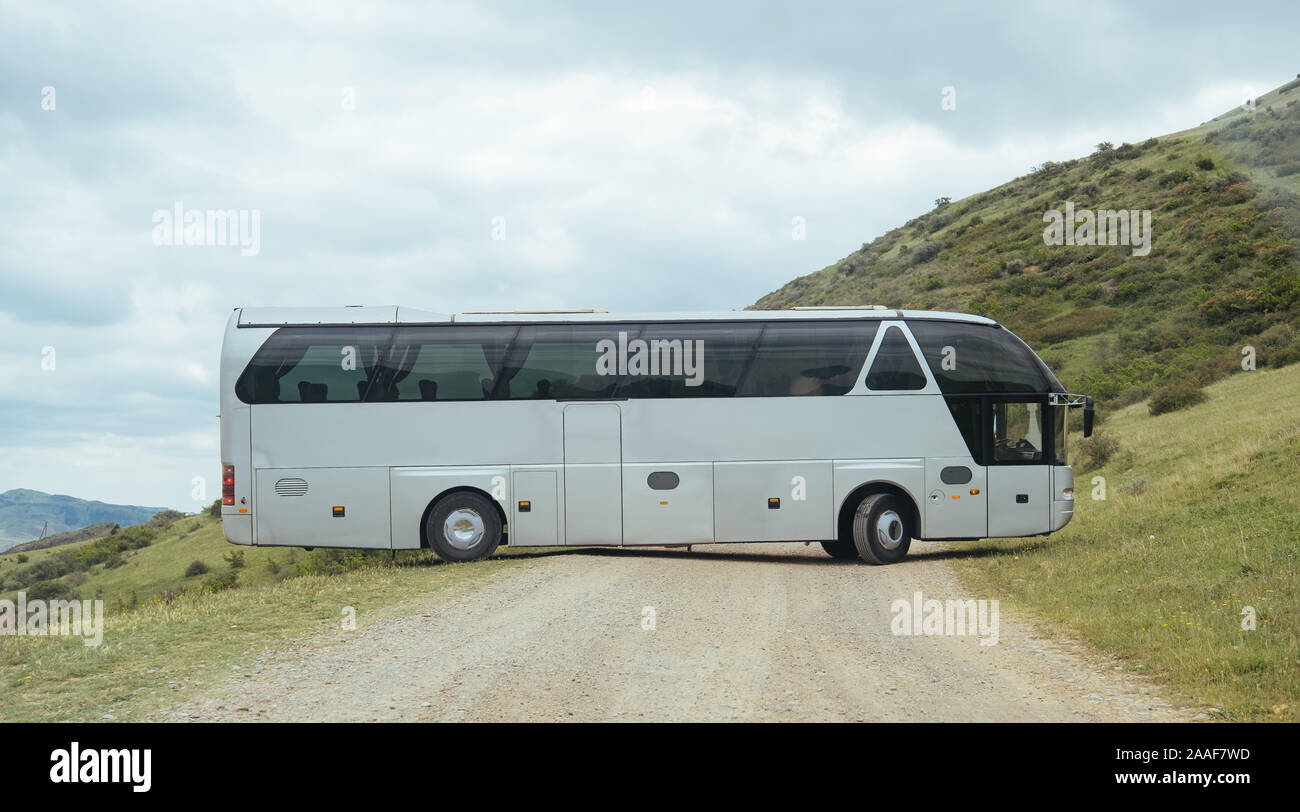 White BUS on the road in Geogrian Mountains Stock Photo