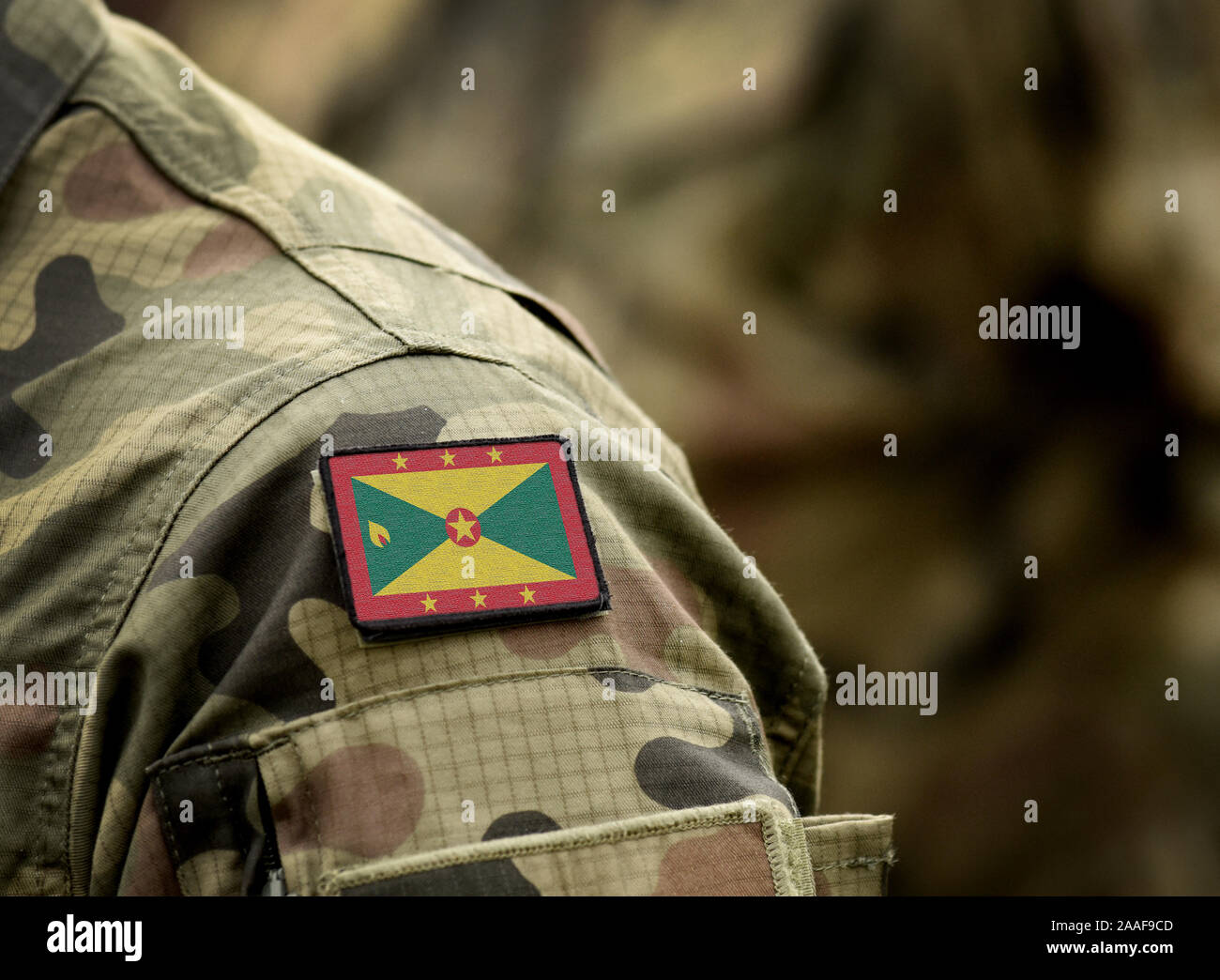Flag of Grenada on military uniform. Army, armed forces, soldiers. Collage. Stock Photo