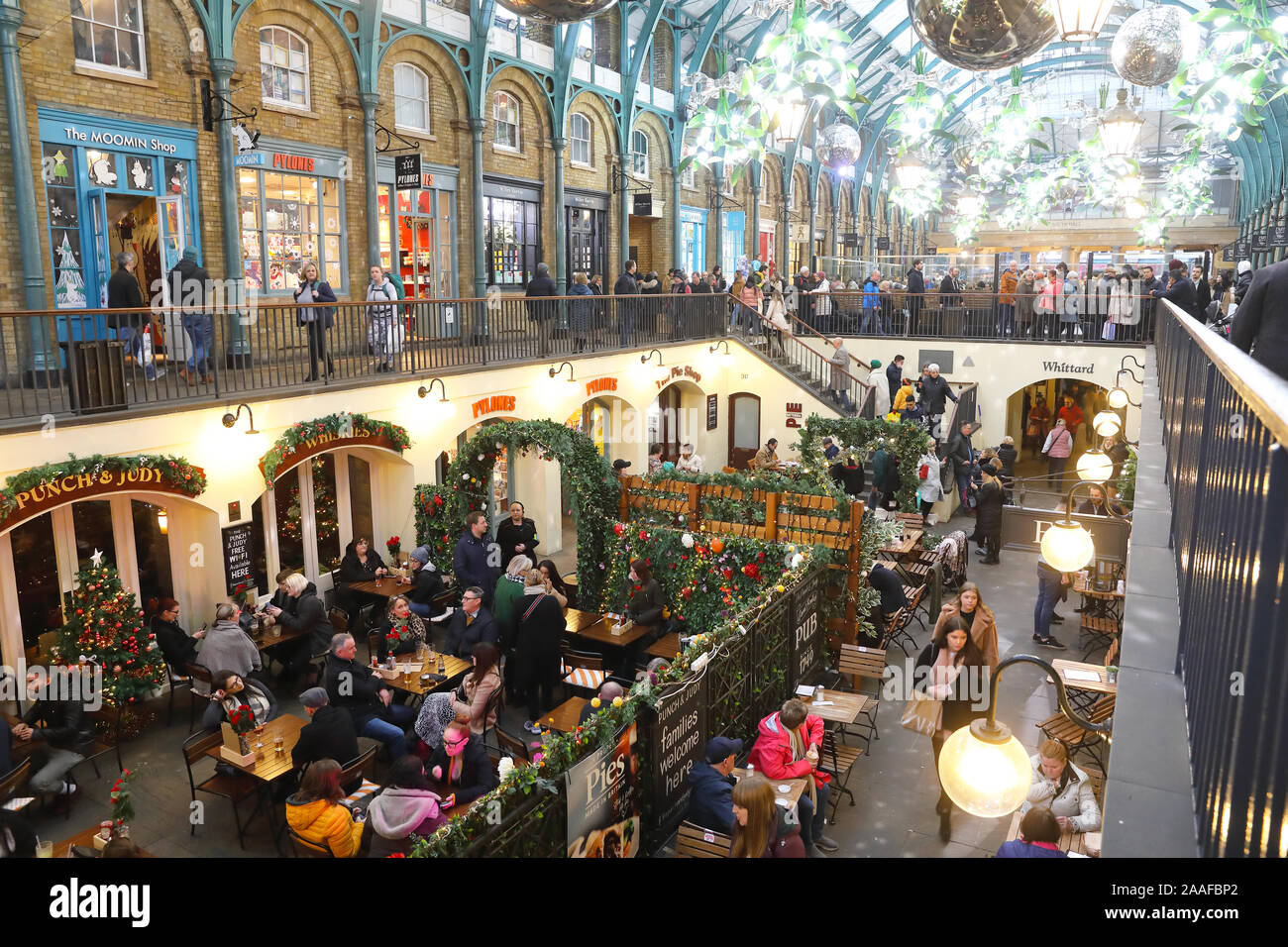 Sitting outside the Punch and Judy 18th century pub in Covent Garden, at Christmas time, in