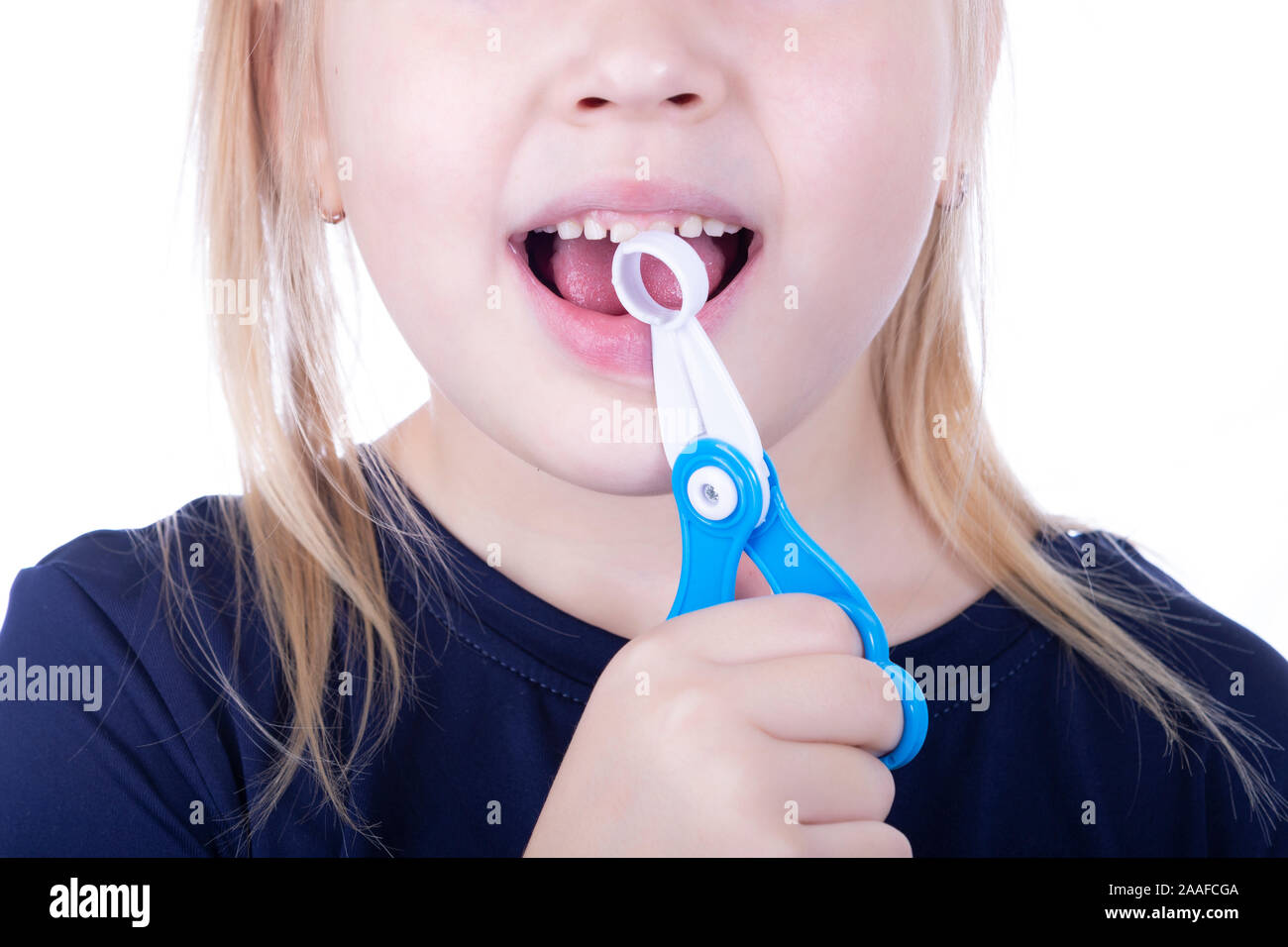 Little girl pull out a tooth with toy pliers on a white background Stock Photo Alamy
