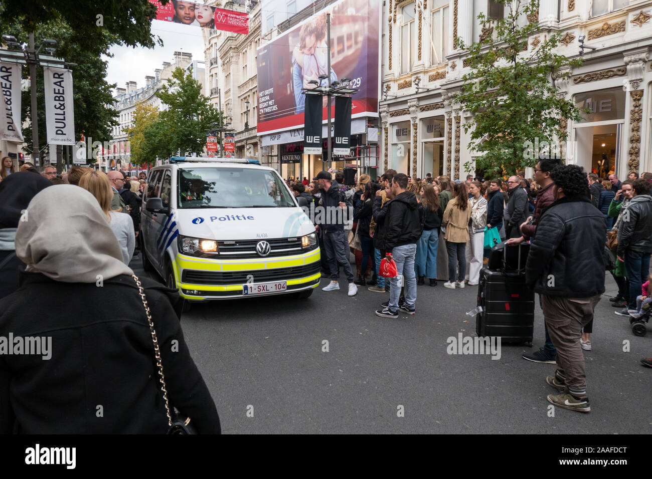 Police car making its way through a crowd of people on the Meir in