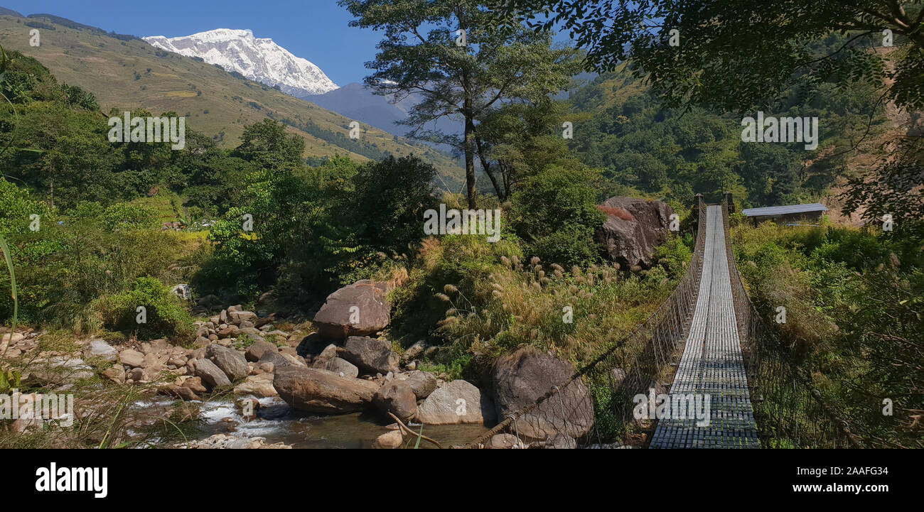 Footbridge, Madi River valley, Himalayas with Lamjung Himal in background Annapurna region, Nepal. Stock Photo