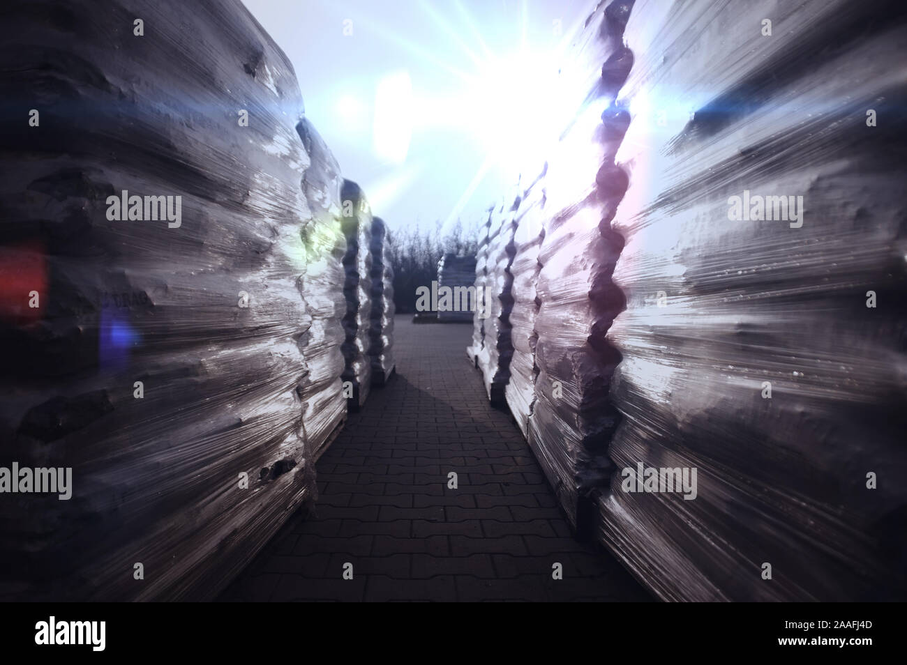 Goods in foil on pallets. Logistics, shipping and delivery. External storage. Stock Photo