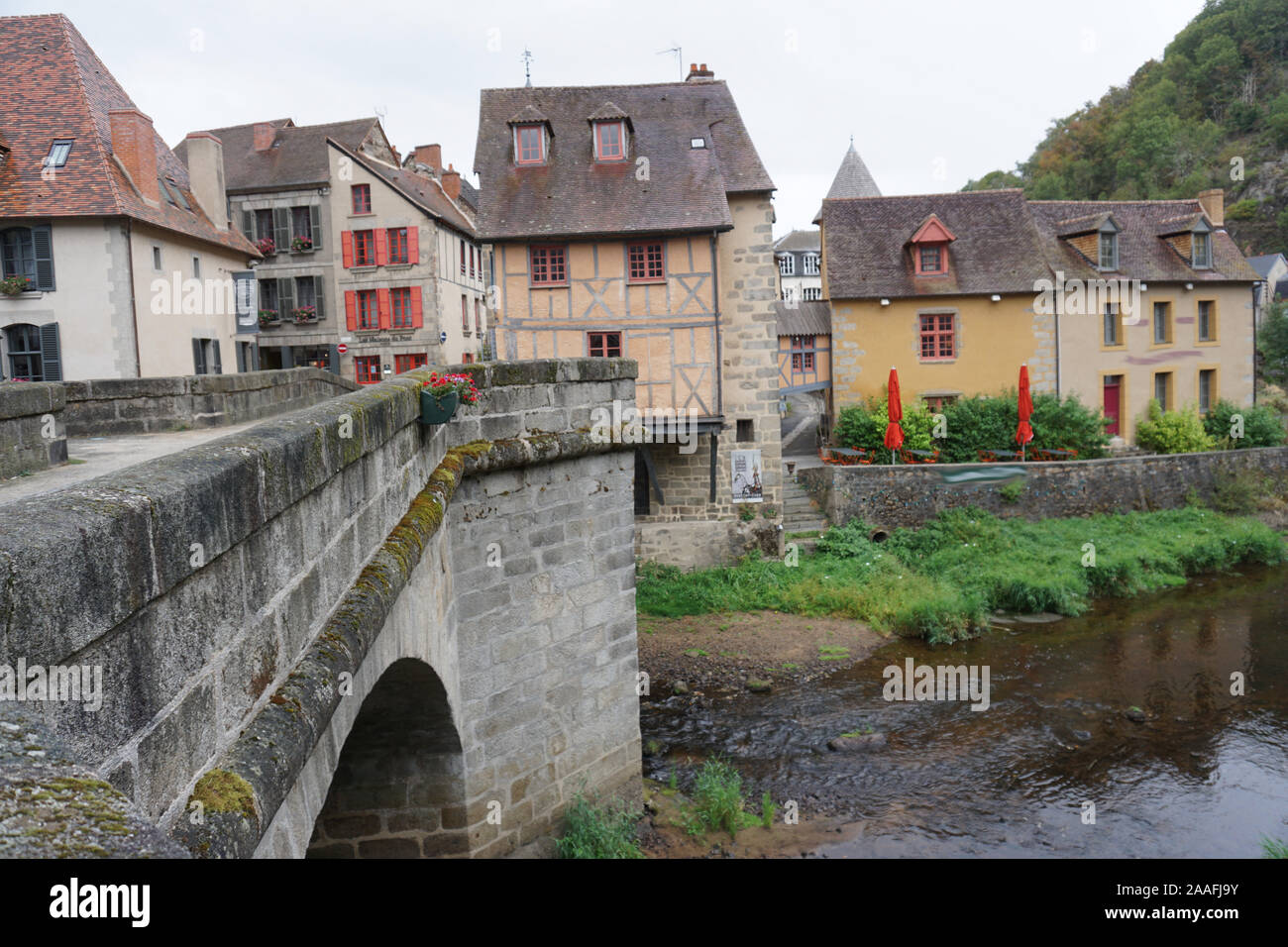 view of a small typical old stone village and bridge in France Stock Photo