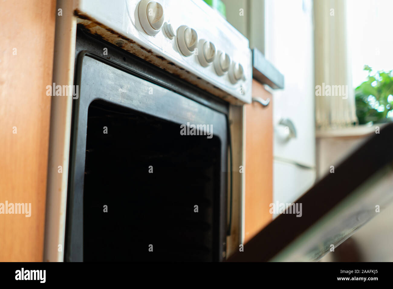 opening the gas oven in kitchen while baking and cooking Stock Photo