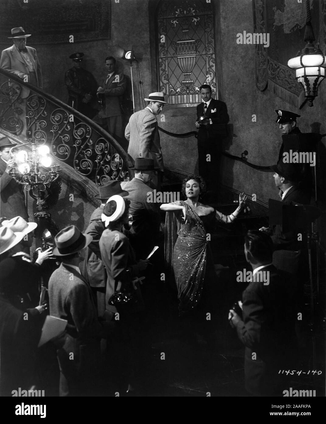GLORIA SWANSON as Norma Desmond staircase finale with reporters news cameramen and policemen in SUNSET BOULEVARD 1950 director BILLY WILDER writers CHARLES BRACKETT BILLY WILDER and D. M. MARSHMAN Jr Costume design EDITH HEAD Paramount Pictures Stock Photo