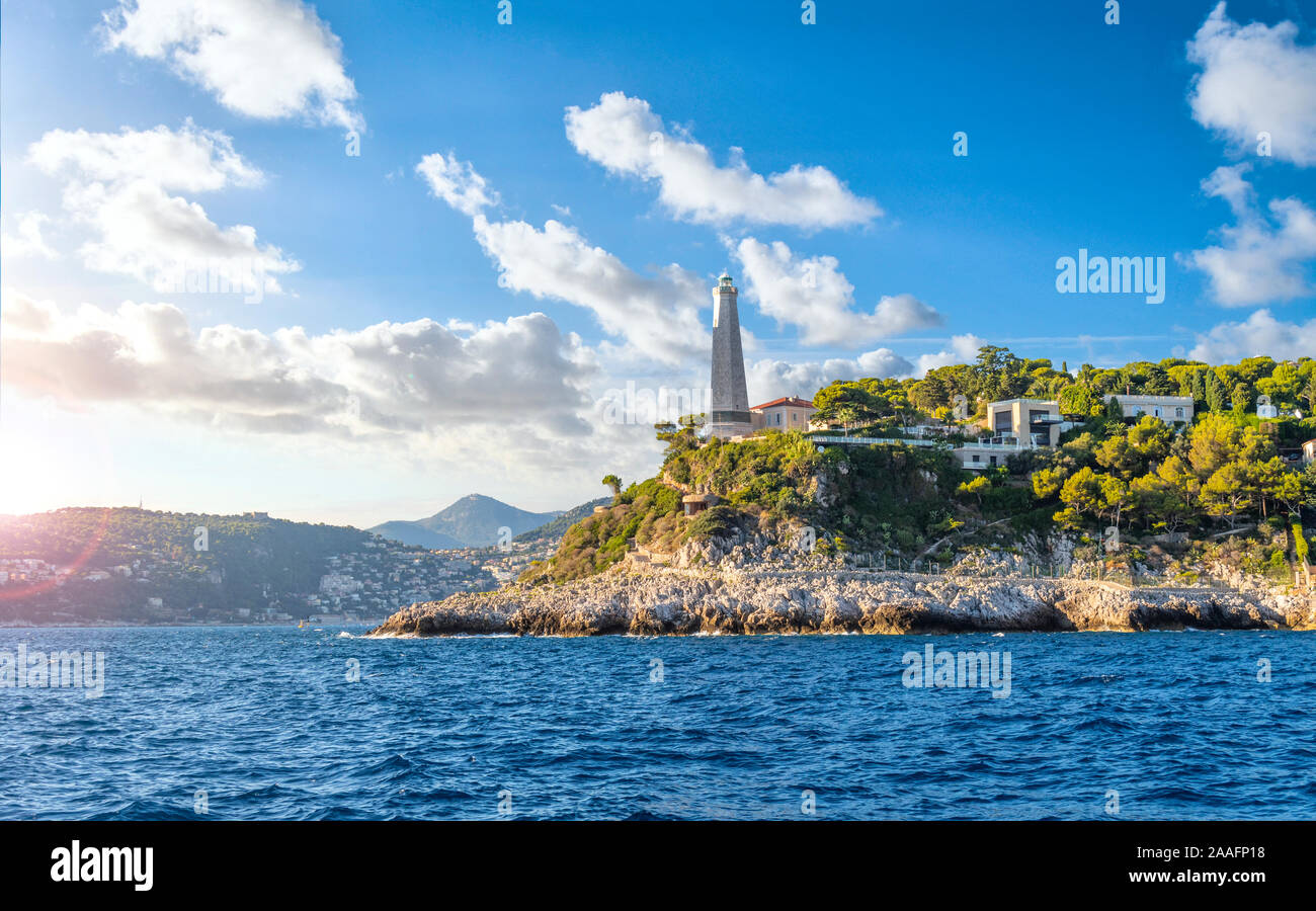 View from the Mediterranean Sea of the Saint Jean Cap Ferrat lighthouse as the sun begins to set on the French Riviera in the South of France. Stock Photo