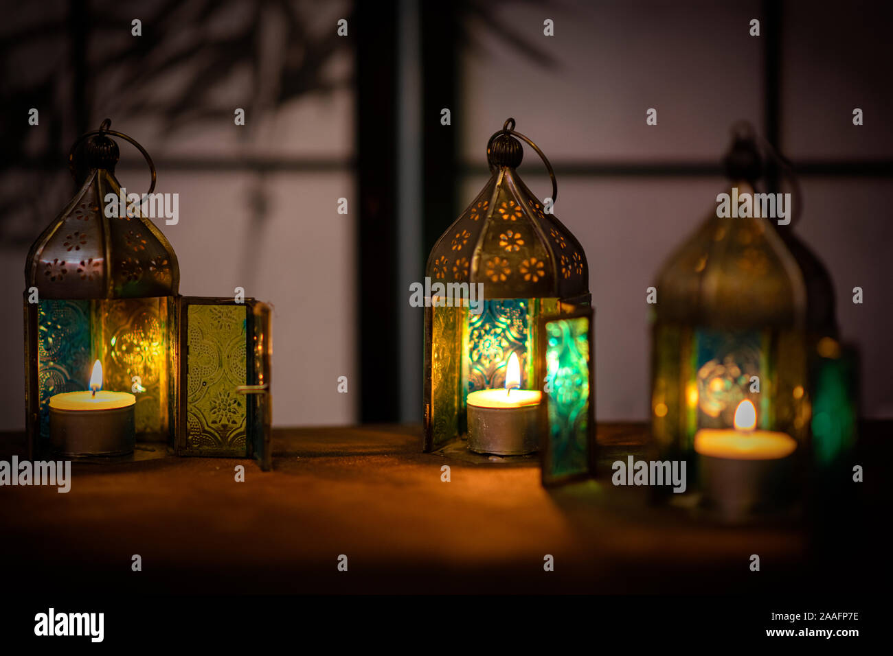 Morroccan lamps with tea lights against a dark background. Stock Photo