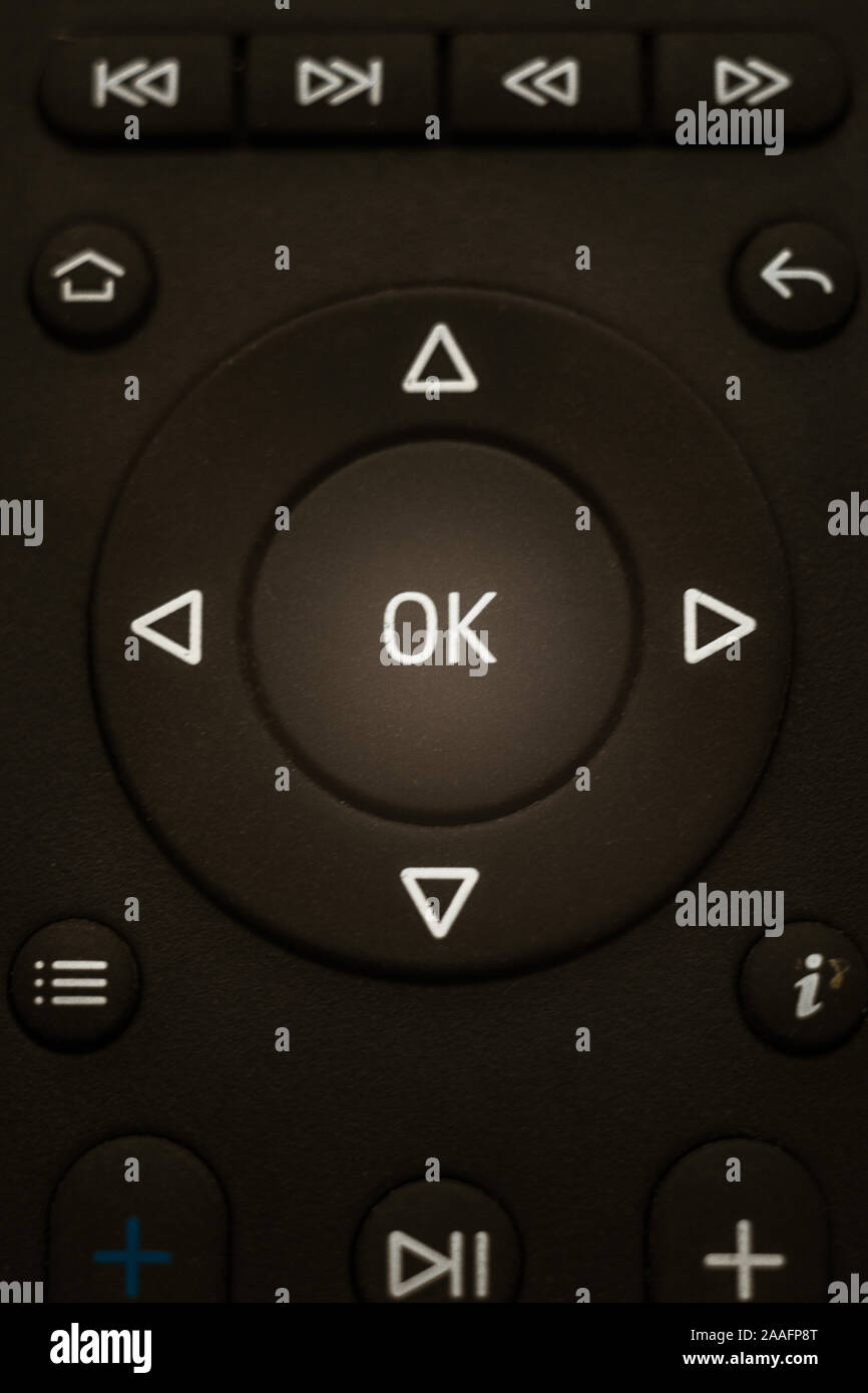 Black remote control close-up, OK menu in center. Stock Photo