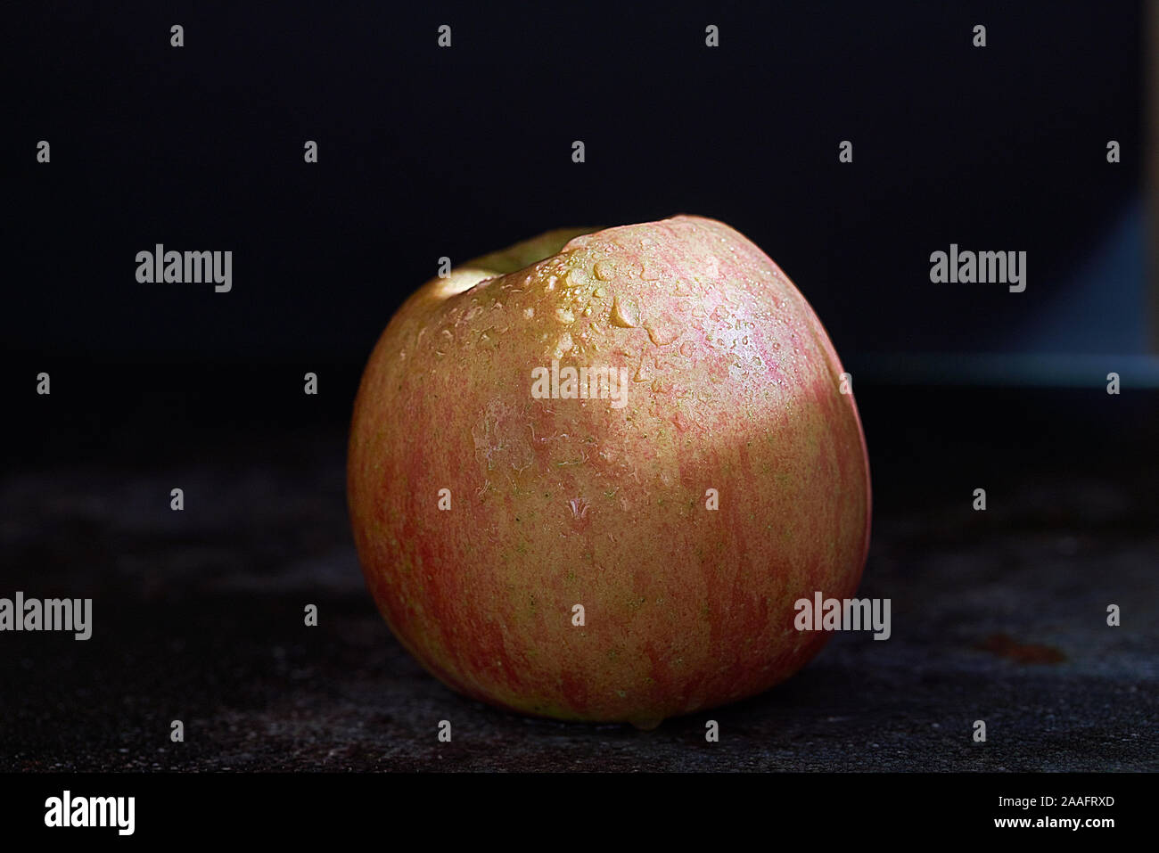 Fuji apple on dark background Stock Photo