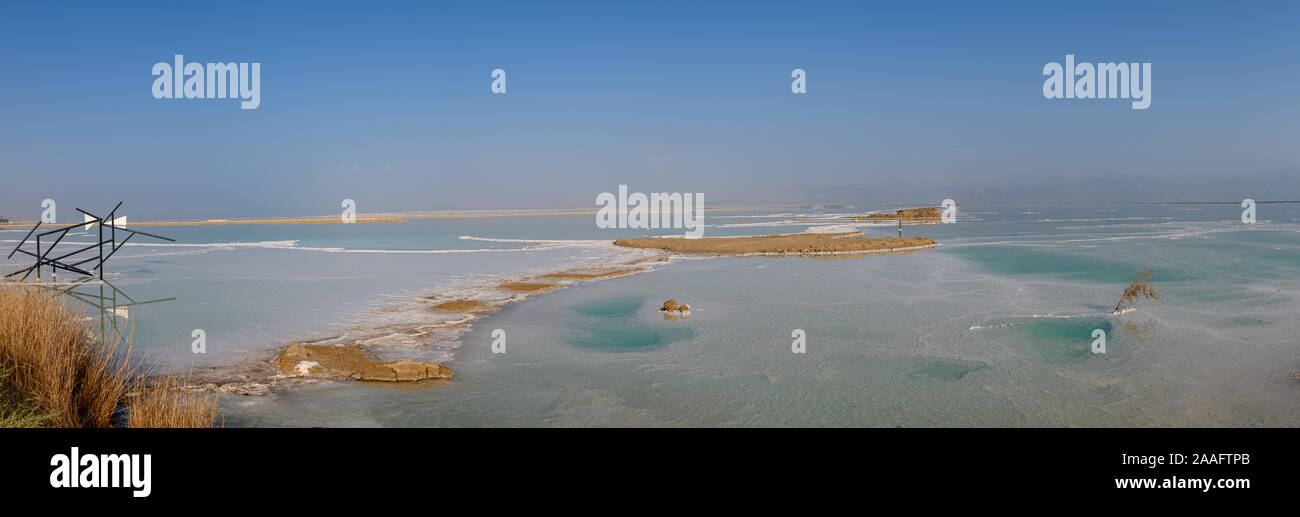 View of Dead Sea coastline with it's beautiful sand and salt in the middle of the water. Aerial shot captured from the shore Stock Photo