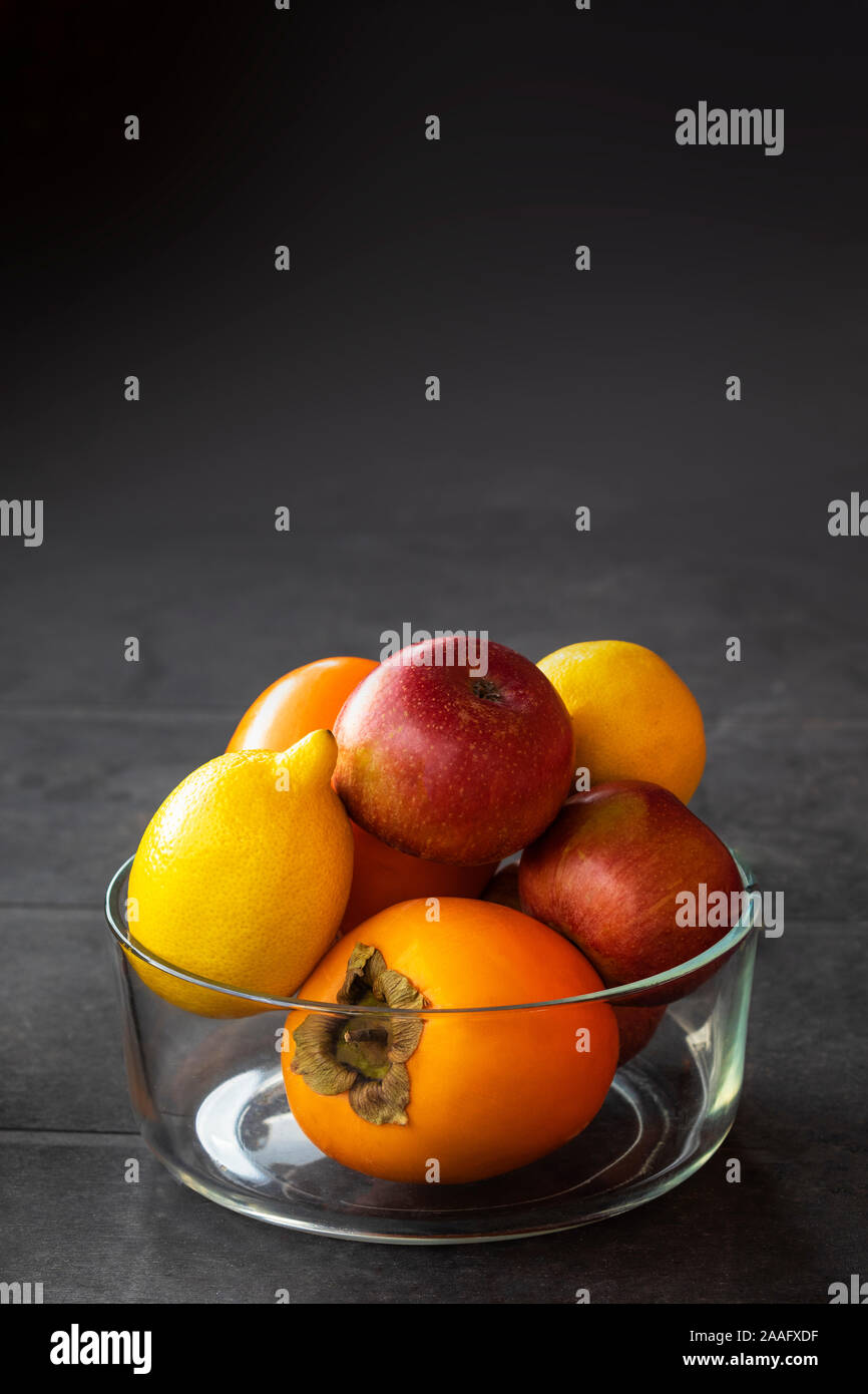 Beautiful Fresh fruits Assorted fruits colorful,clean eating,in glass pot with gray background Stock Photo