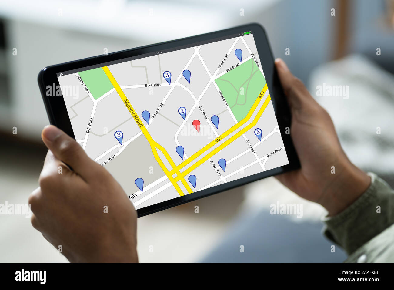 Close-up Of A Person Sitting In A Car Using GPS Service On Digital Tablet Stock Photo
