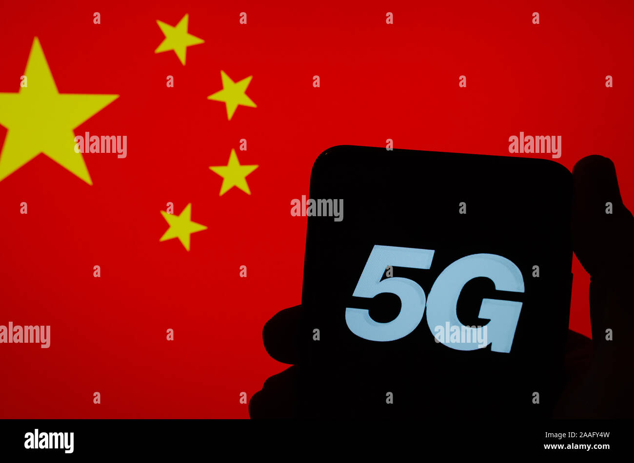 5G letters on a silhouette of a smartphone hold in hand with the flag of China on a blurred background screen. Authentic photo,not a montage. Stock Photo