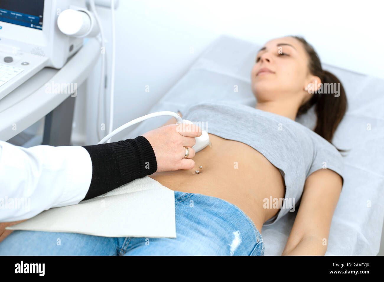 The doctor conducts an ultrasound diagnosis of the patient abdomen and internal organs Stock