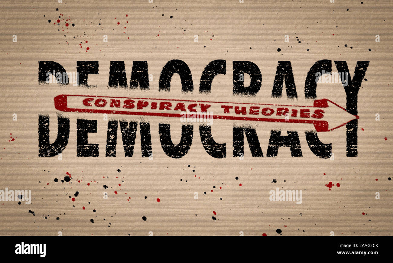 Conspiracy Theories shattering Democracy text on cardboard paint splattered background, concept illustration Stock Photo