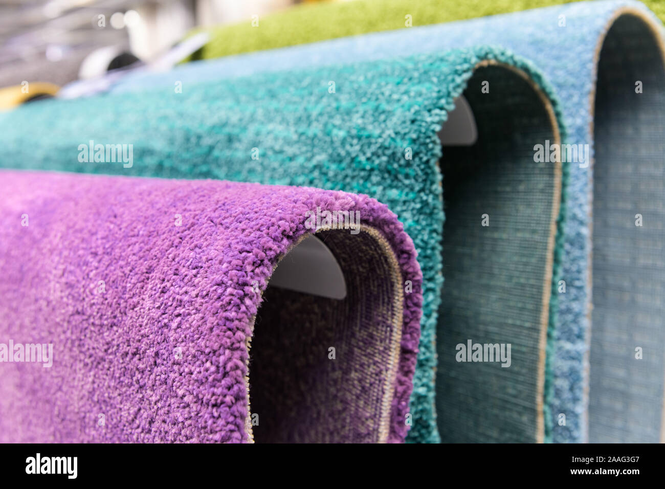 Carpets hanging on the shelves in the carpet store. different carpets