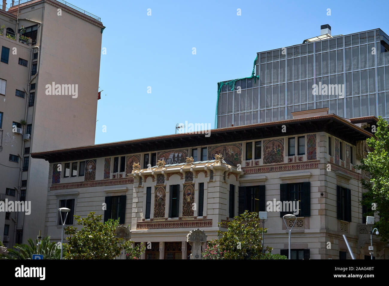 The Palau Ramon Montaner on the Carrer de Roger de Llúria in Barcelona with facade painting and green shutters Stock Photo