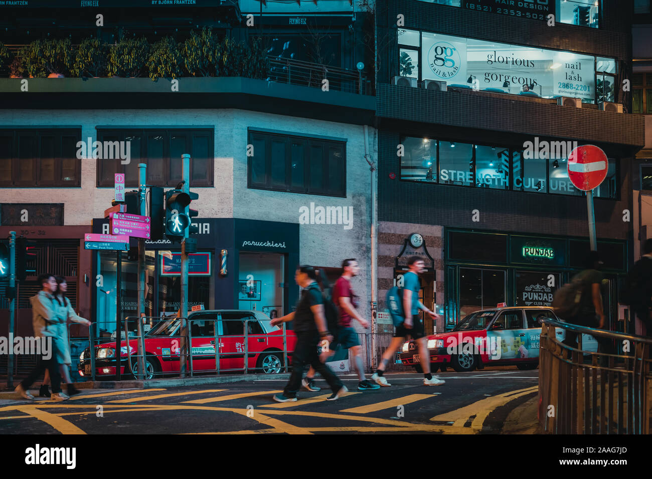 People walking around Wyndham Street at night. The populated areas and international business and financial center in hong kong Stock Photo