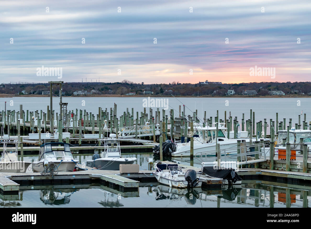 View of boats docked in marina at sunset Stock Photo