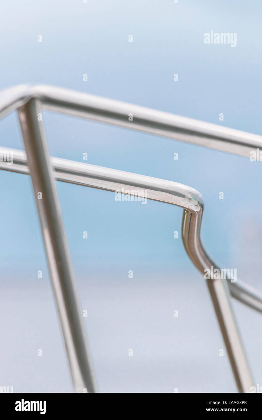 Dreamy abstract soft focus view of steel chrome pipe tubing against pastel colored skies; nautical vibe Stock Photo